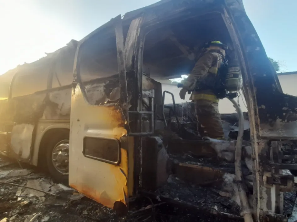 Fotografía cedida por Relaciones Públicas del Cuerpo de Bomberos de Panamá donde se ven bomberos mientras trabajan para apagar un incendio en un bus que trasladaba a 57 migrantes, en la carretera panamericana.