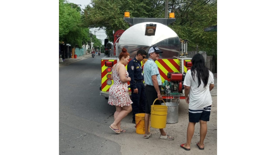 Los ciudadanos con baldes de diversos tamaños arriban al carro de Bomberos para suministrarse de agua. Los ciudadanos con baldes de diversos tamaños arriban al carro de Bomberos para suministrarse de agua.